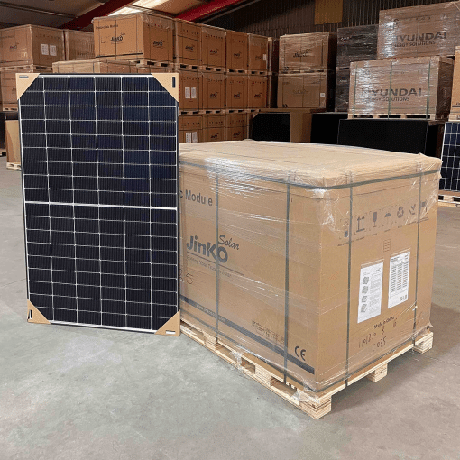 Jinko Solar Tiger Neo N-Type 440wp zonnepaneel naast een pallet met verpakte panelen in een magazijn